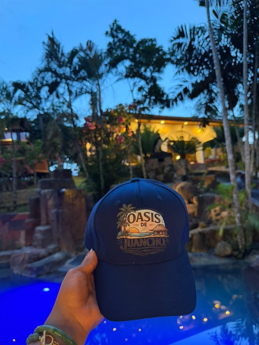 Gorra del Oasis de Juancho junto a la piscina, al atardecer